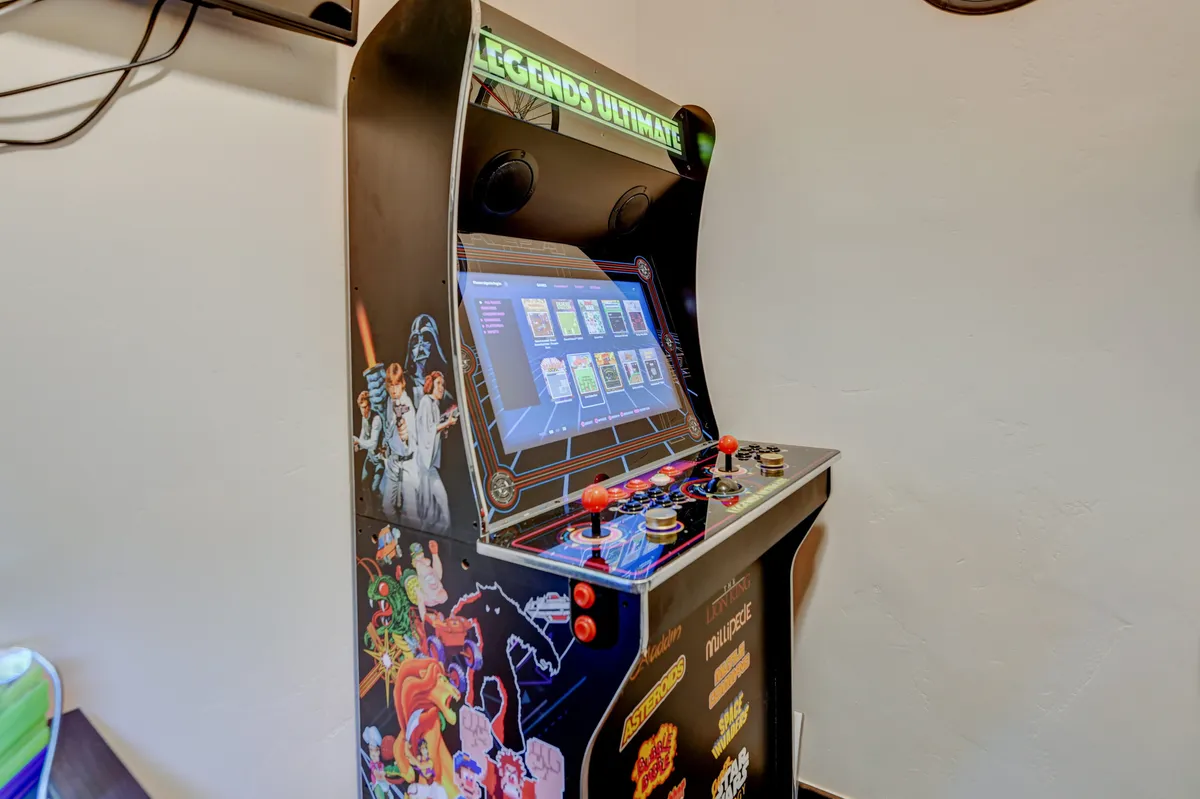 Close-up view of a vibrant arcade game machine, showcasing its eye-catching graphics and interactive control panel. The scene exudes energy and invites friendly competitions and nostalgic moments.